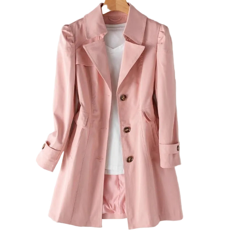 Pink trench coat on a hanger against a white background