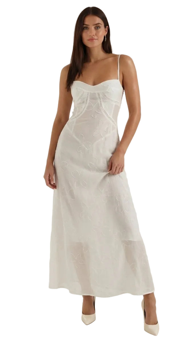 Woman wearing a white slip dress against a white background