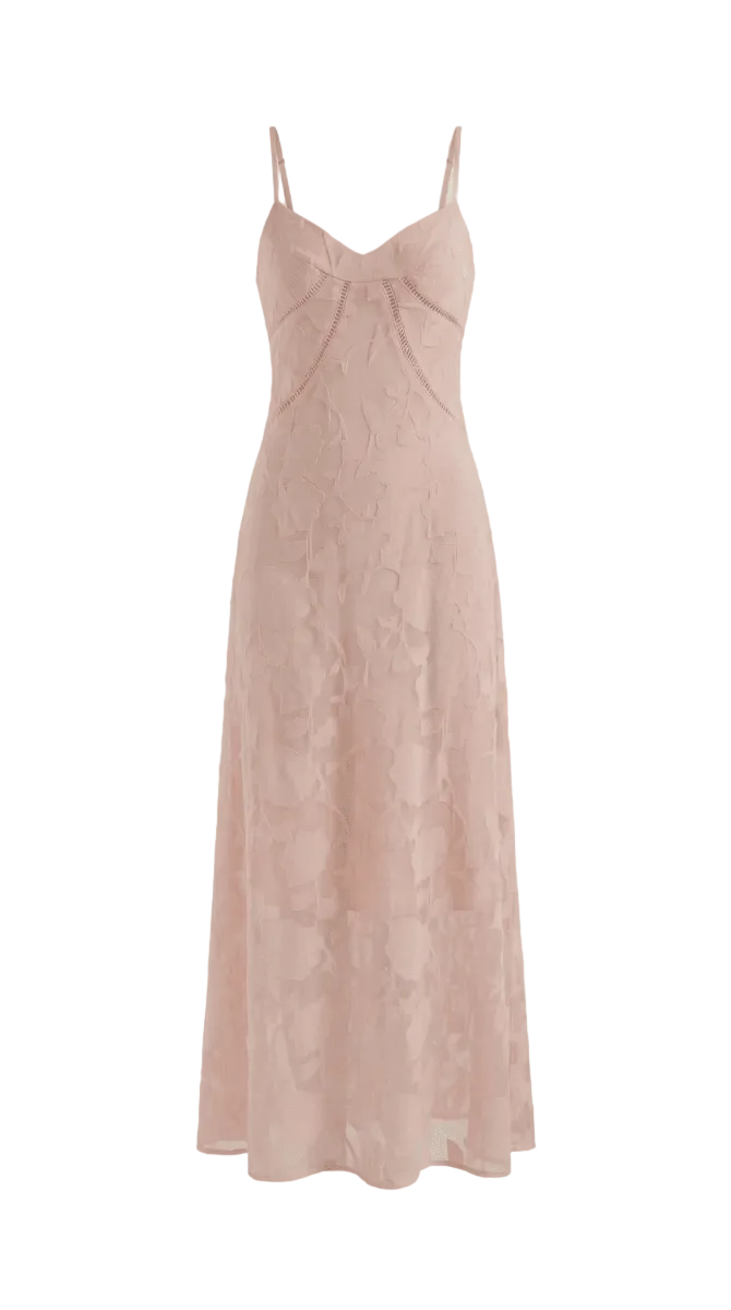 Pink slip dress on a light beige background