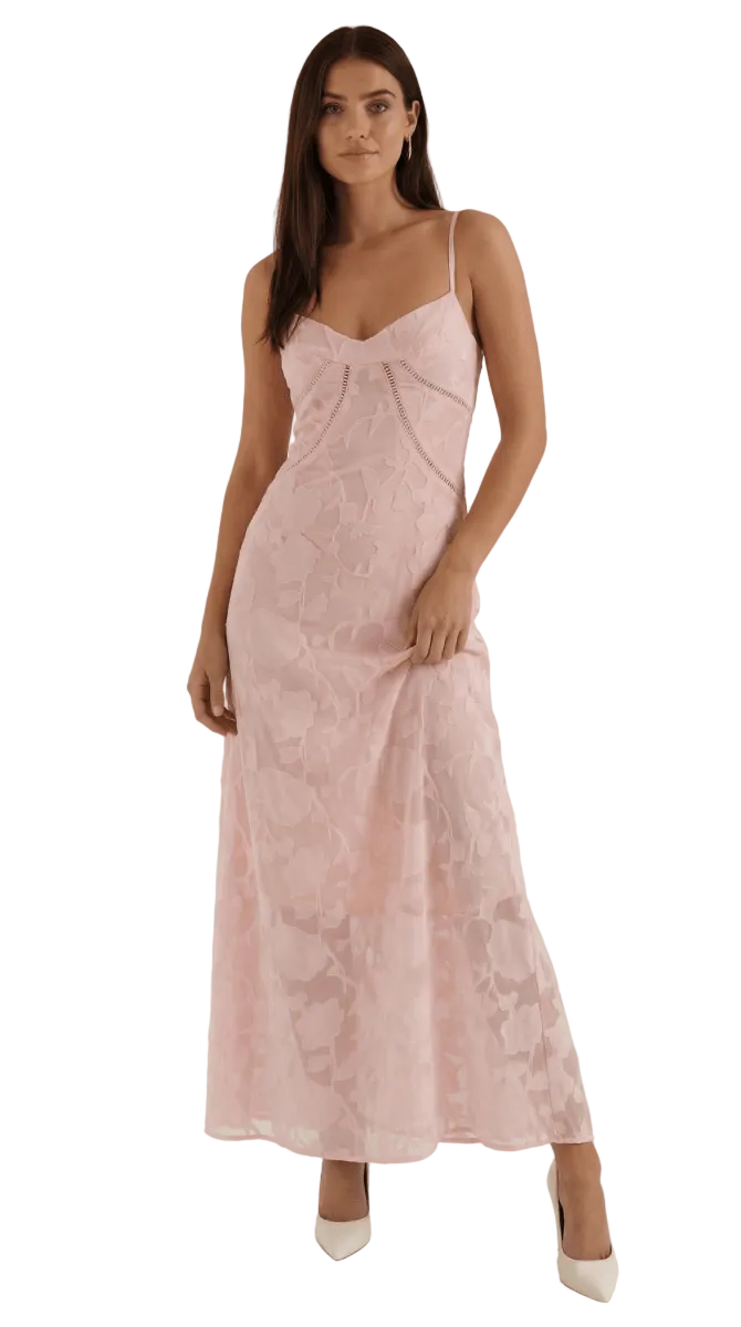 Woman wearing a pink lace dress against a white background