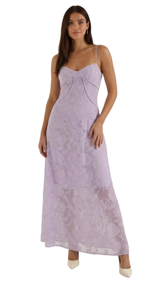 Woman wearing a lavender dress against a white background