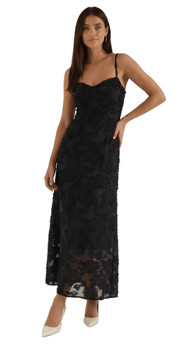 Woman wearing a black lace dress on a white background