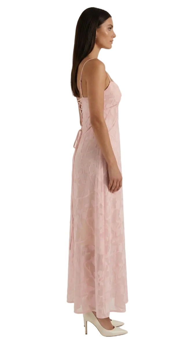 Woman wearing a pink lace dress on a white background
