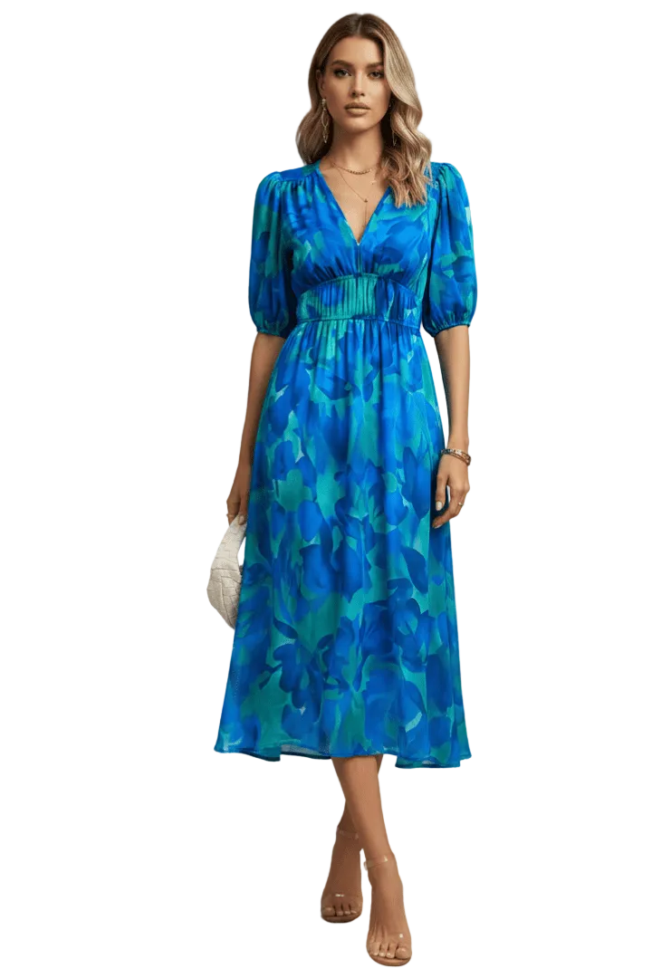 Woman wearing a blue floral dress against a white background