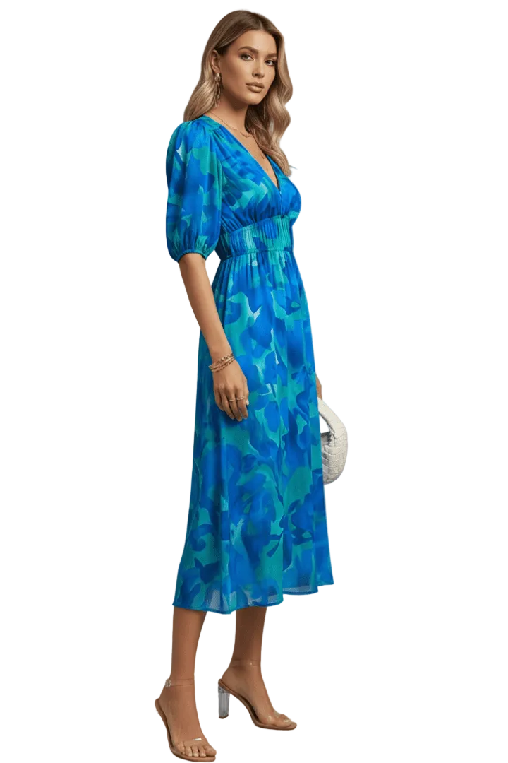Woman wearing a blue patterned dress on a white background