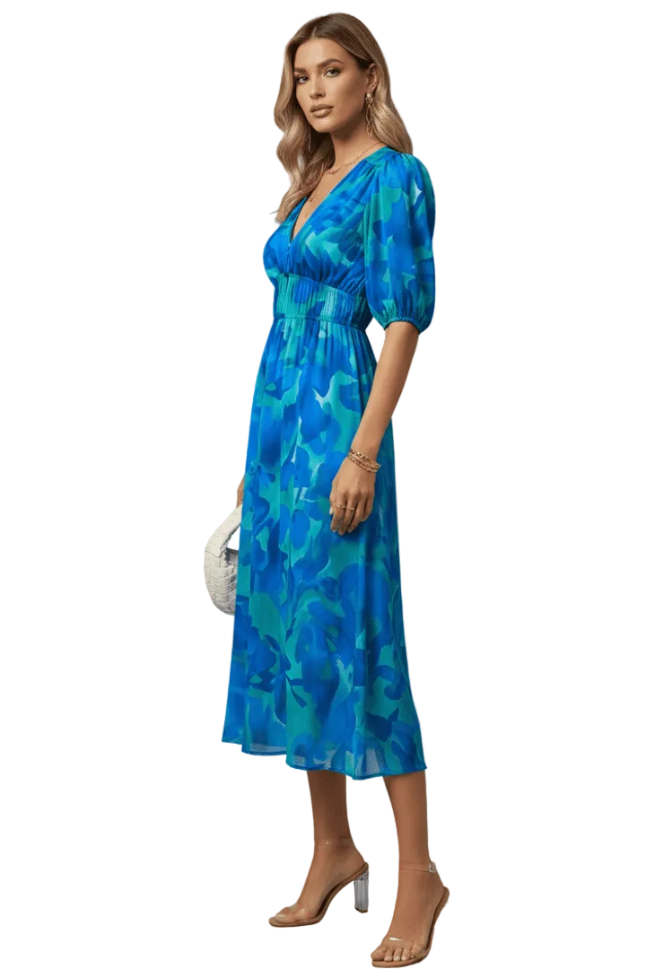Woman wearing a blue floral dress against a white background