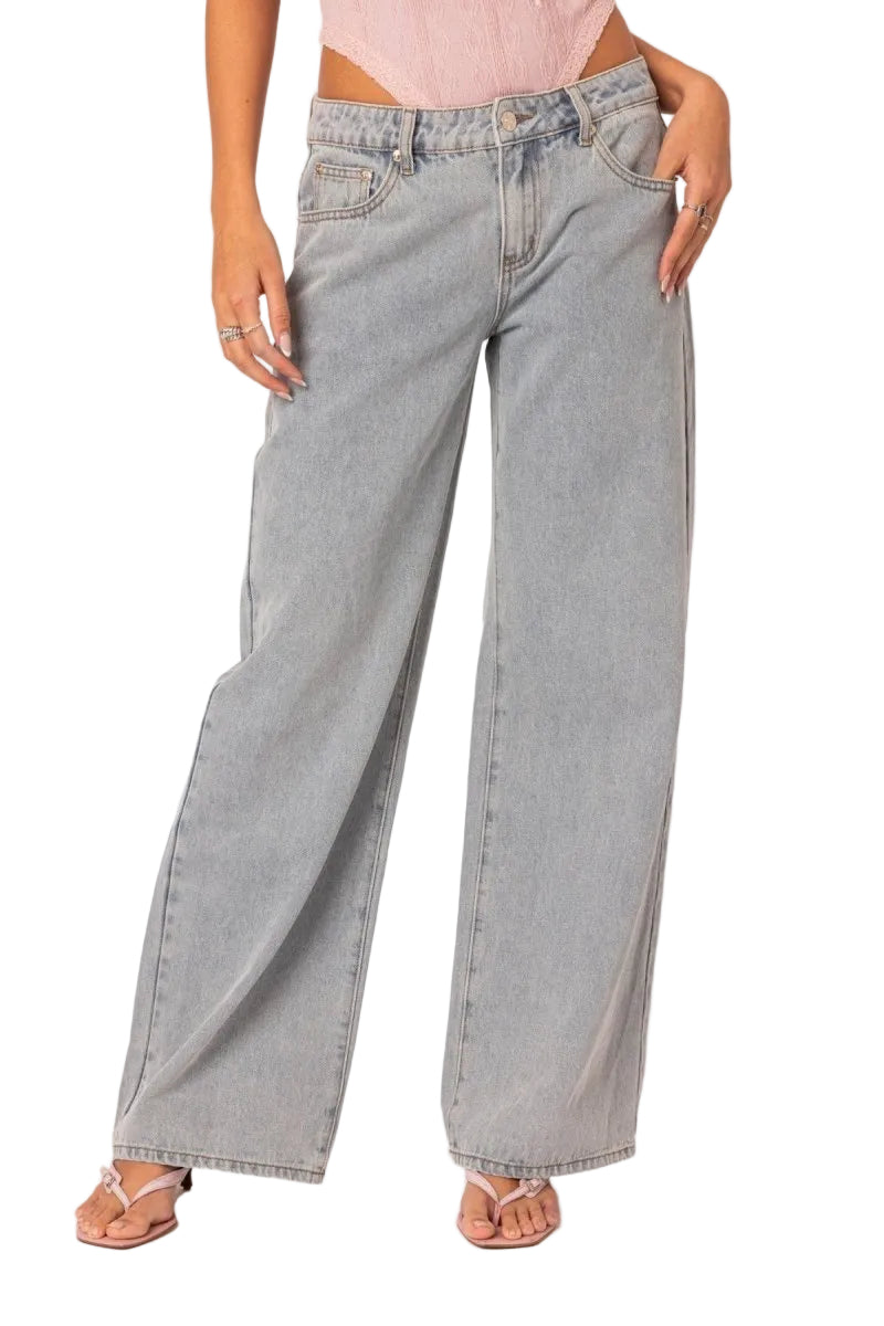 Person wearing light gray wide-leg jeans on a white background