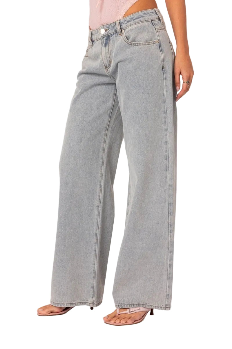 Light gray wide-leg jeans worn by a person on a white background