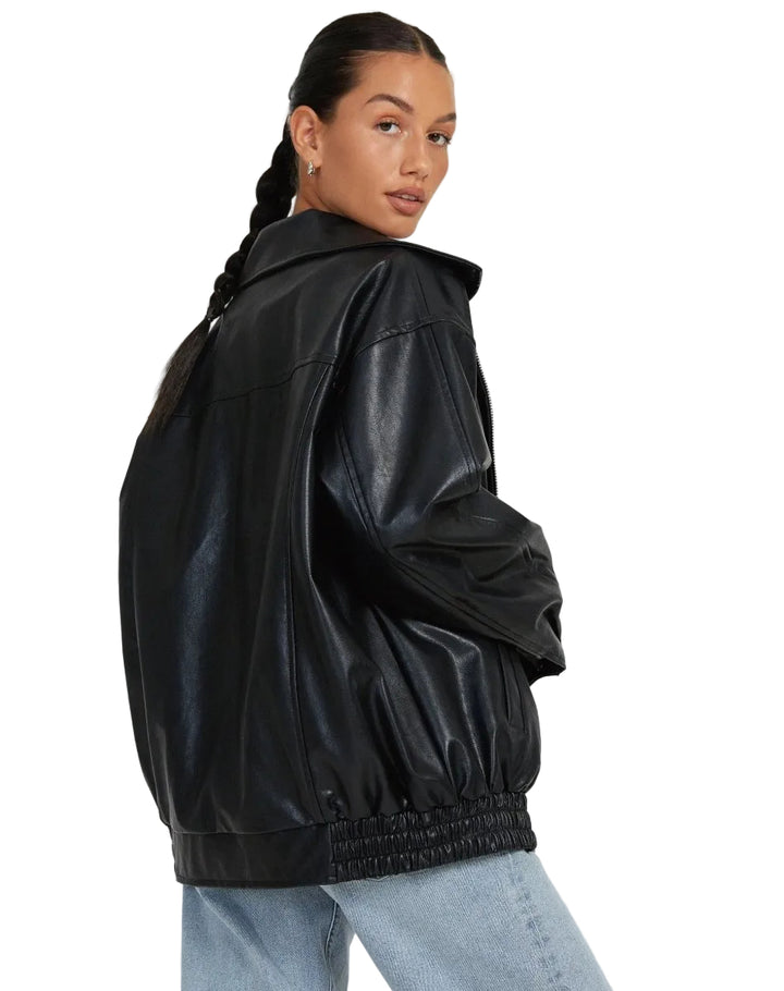 Person wearing a black leather jacket on a white background