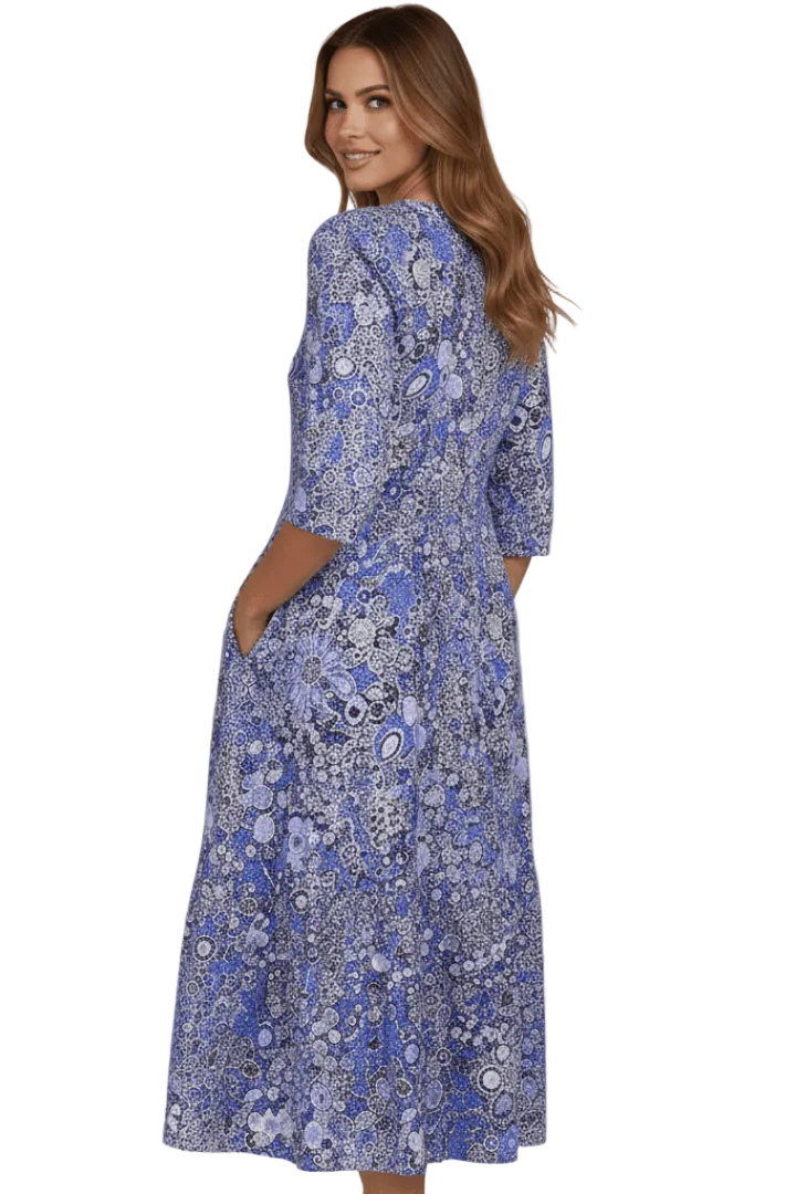 Woman wearing a blue floral dress on a white background