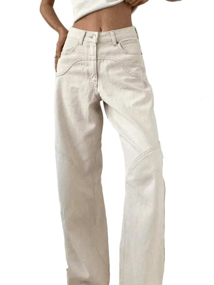 Person wearing light-colored jeans sitting on a white background
