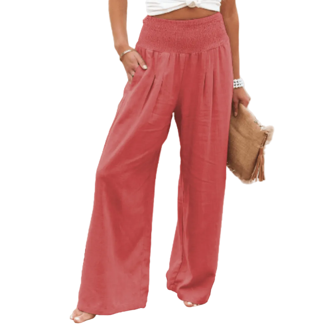 Person wearing red wide-leg pants on a white background.